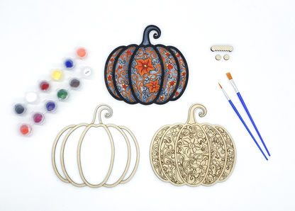 Complete gothic pumpkin DIY paint kit with finished piece, blank layers, paints, brushes and hardware side by side