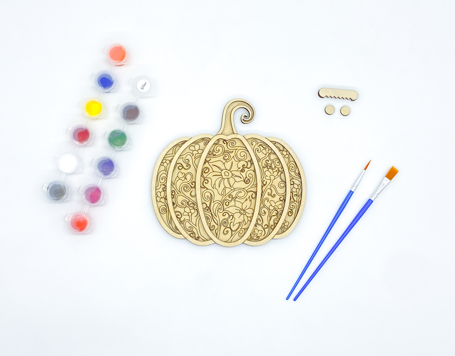 Unpainted gothic pumpkin layered wood kit with stacked basswood pieces, paint pots, brushes and hanger hardware