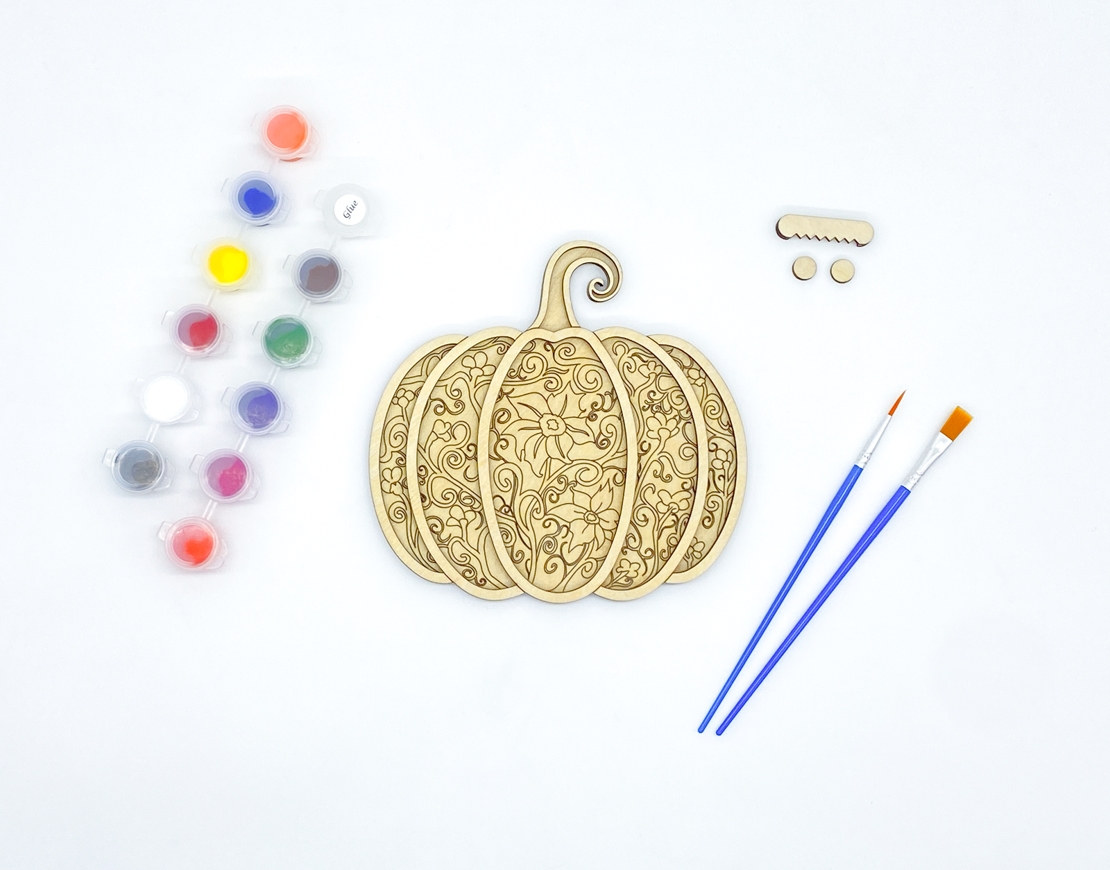 Unpainted gothic pumpkin layered wood kit with stacked basswood pieces, paint pots, brushes and hanger hardware