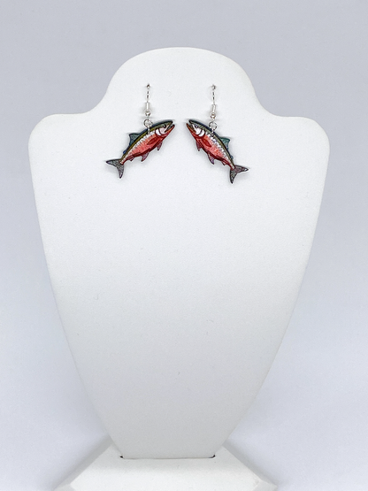 Fish-shaped earrings on a white mannequin bust against a light gray background