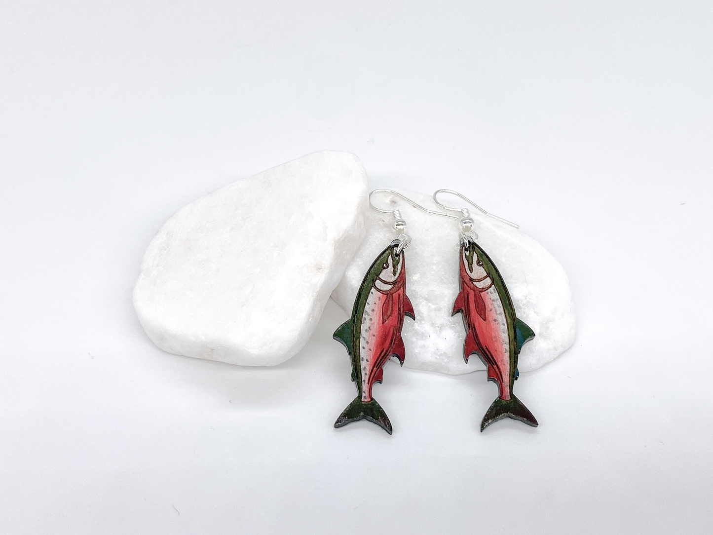 Fish-shaped earrings on a white background