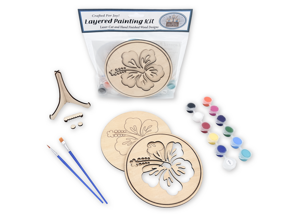Packaged Hawaiian Hibiscus layered painting kit with unfinished wood pieces, paint pots, brushes, glue, display stand, and hardware.