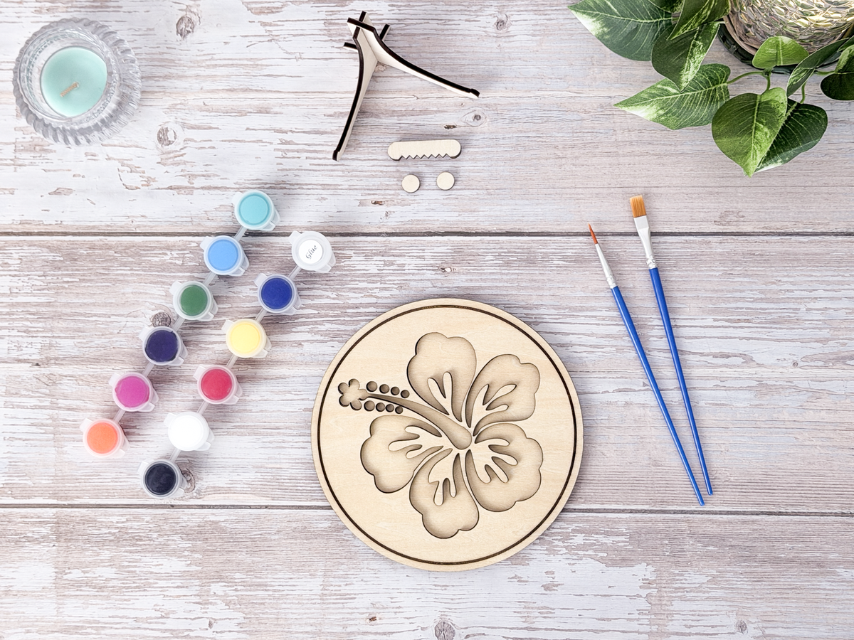 Hawaiian Hibiscus DIY wood painting kit with unfinished pieces, paint pots, and brushes.