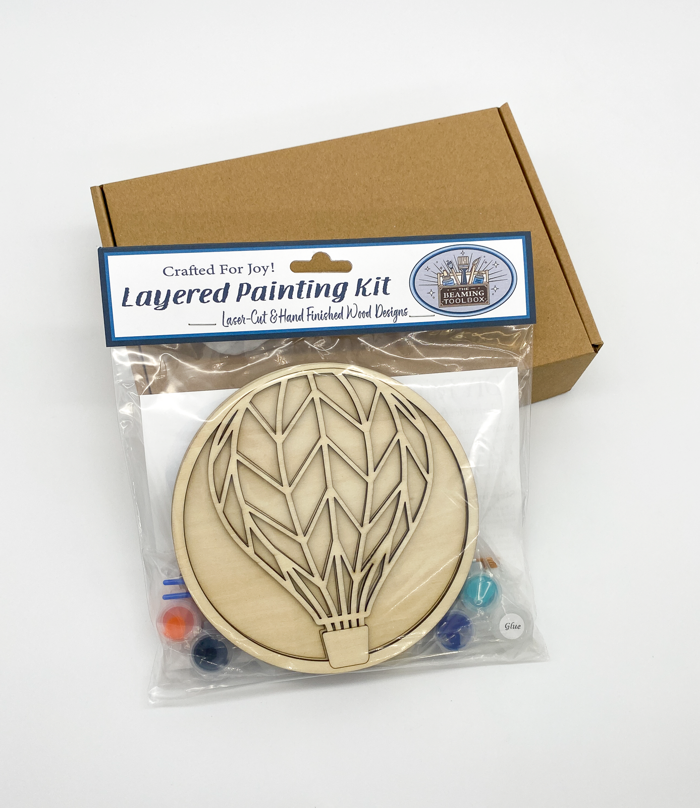 Front of Hot Air Balloon DIY paint kit packaging showing layered wood hot air balloon design and included painting supplies