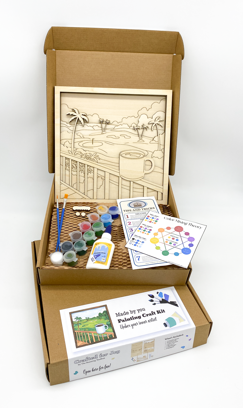 Boxed Lanai Mornings 5-layer DIY paint kit packaging showing layered wood tropical morning scene design and all included kit contents such as paint pots and brushes