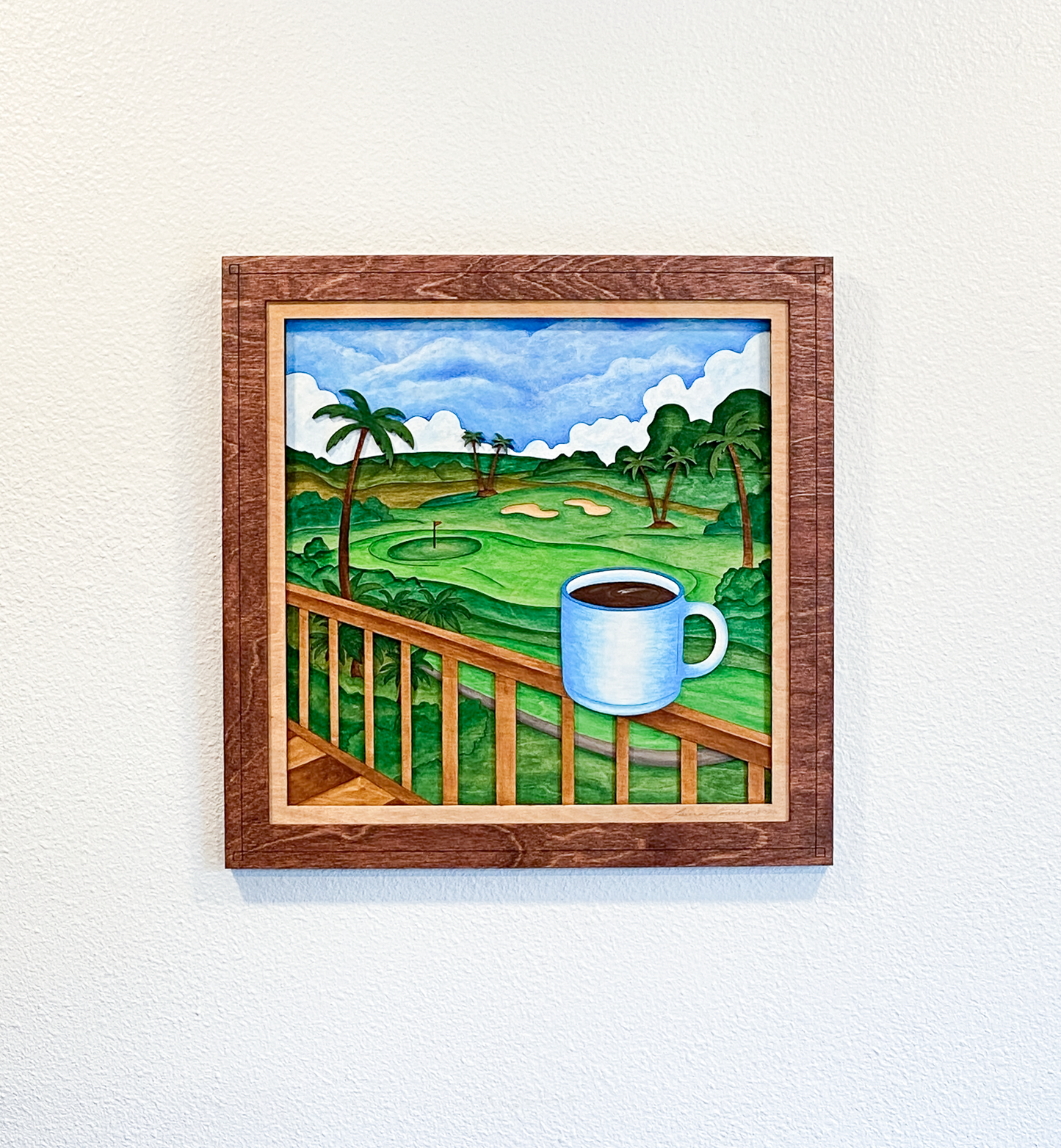 Front view of Lanai Mornings original six-layer sculptural birch plywood artwork featuring tropical greenery, palm trees, clouds, and a blue coffee mug overlooking an island golf course.