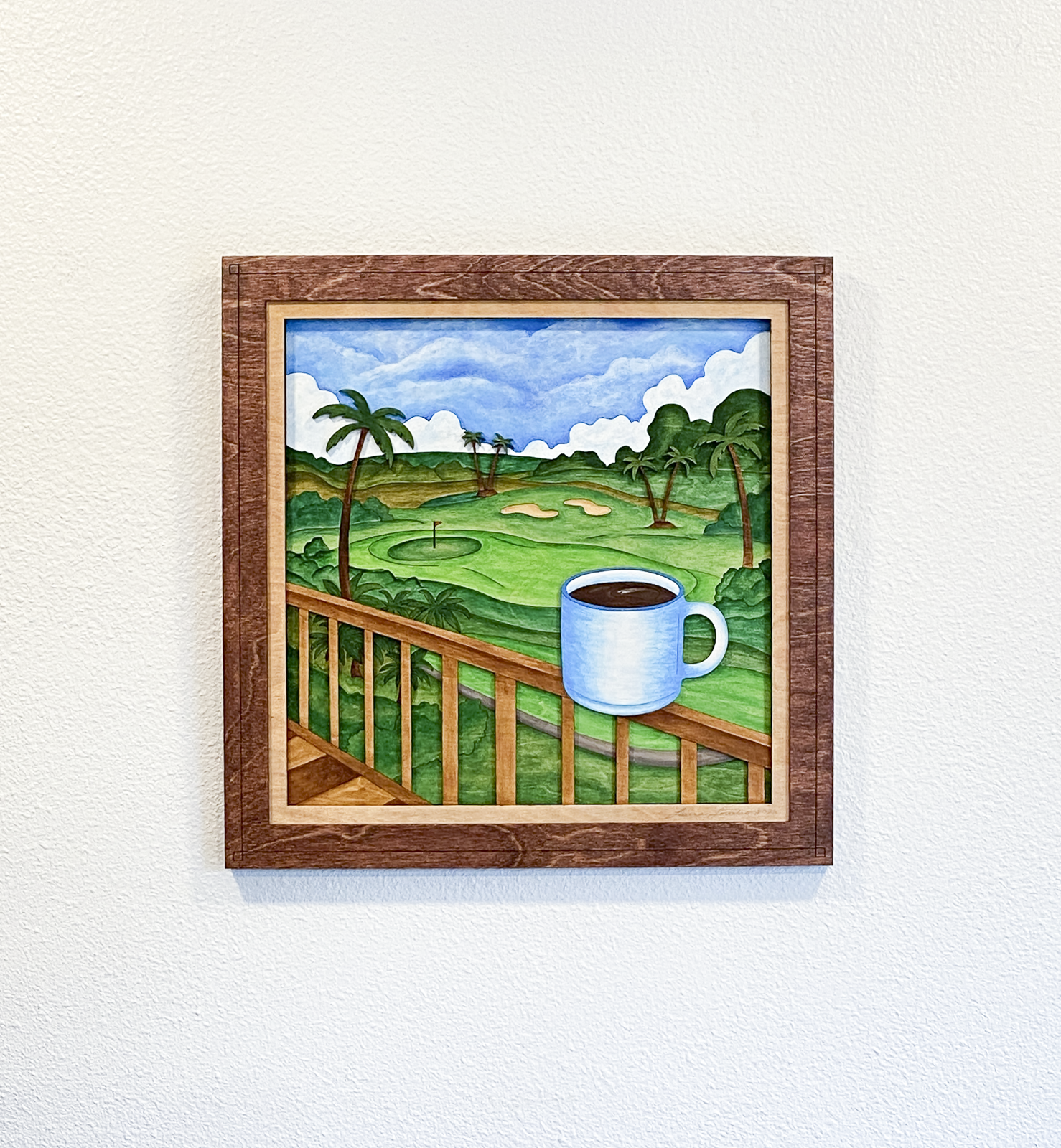 Front view of Lanai Mornings original six-layer sculptural birch plywood artwork featuring tropical greenery, palm trees, clouds, and a blue coffee mug overlooking an island golf course.