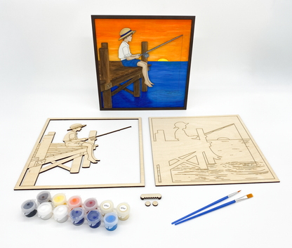 Wooden art project kit of boy fishing with paint supplies on a white background