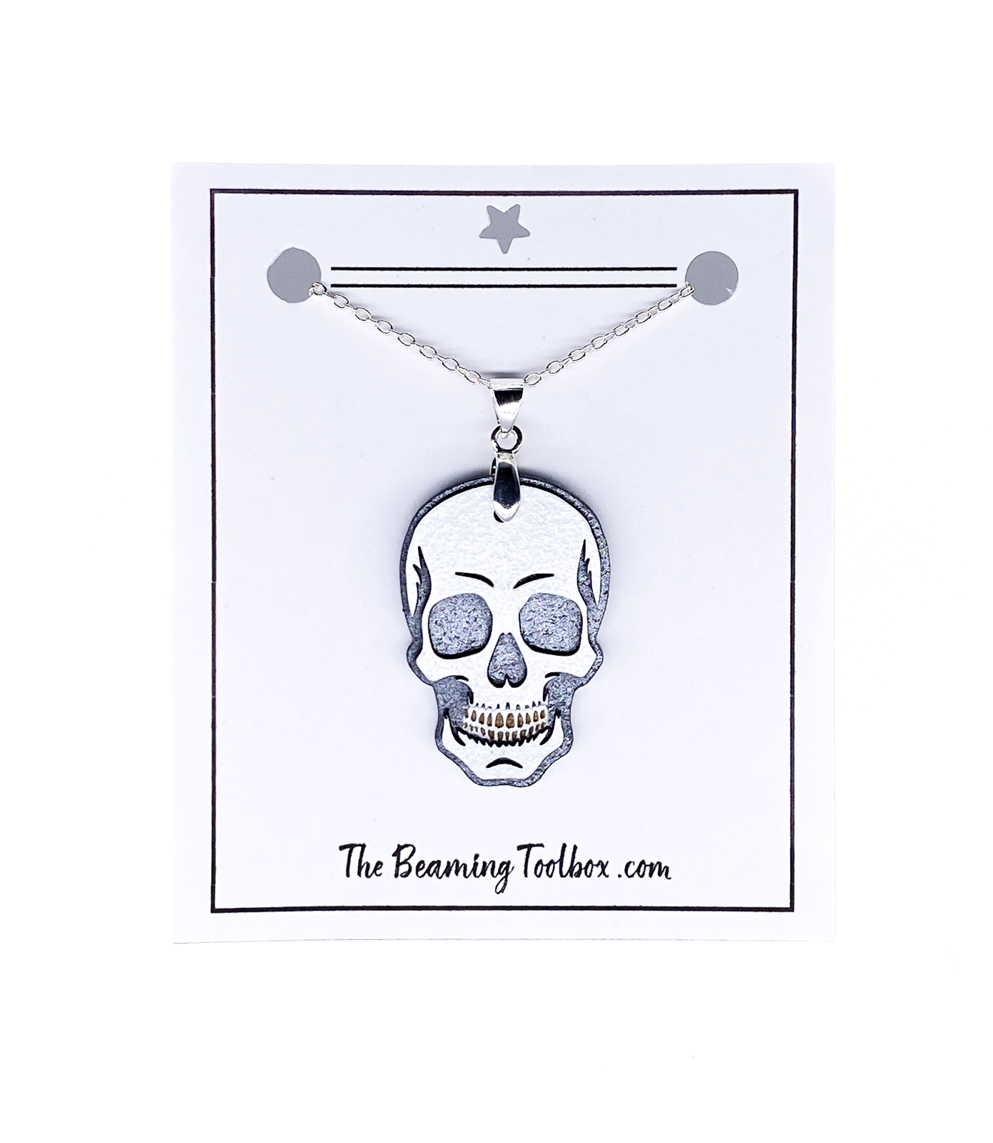 Hand-painted layered wood skull necklace on branded display card with silver-plated chain.