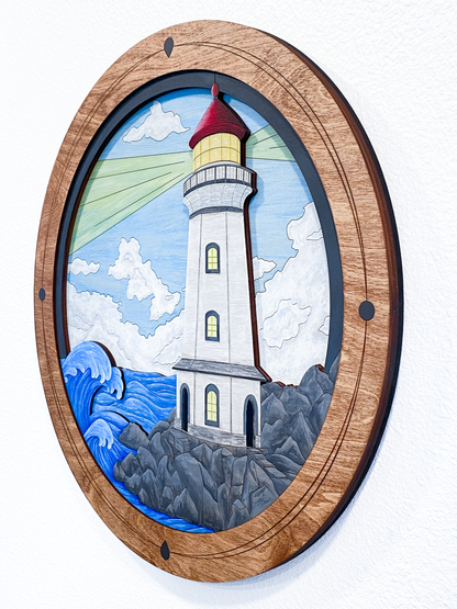 A full view of the finished "Lighthouse on a Rocky Shore" piece in a studio setting, showcasing the vibrant colors and custom-built circular frame.