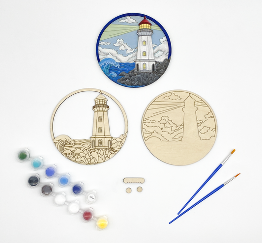 Lighthouse DIY paint kit contents displayed with completed painted lighthouse ocean scene example
