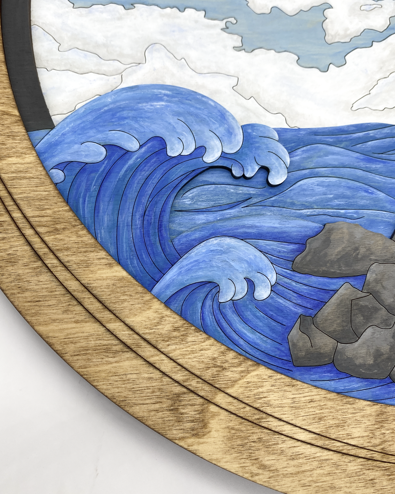 Macro shot of the 4-layer construction showing the depth of the crashing waves and the natural wood grain visible through the blue glazes.