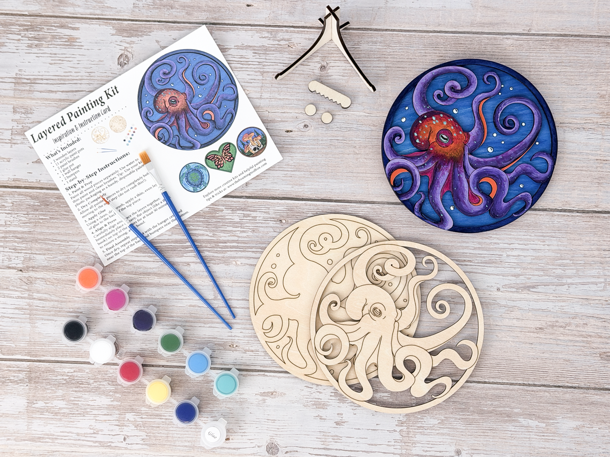 Octopus DIY wood painting kit with unfinished layers, paint pots, brushes, display stand, packaging, and a finished painted example.