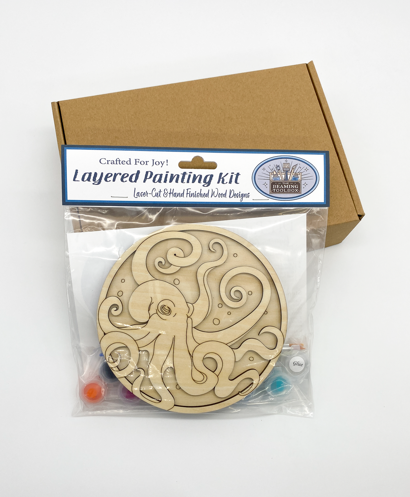 Front of Tangled Treasures octopus DIY paint kit packaging showing layered wood octopus with underwater treasure design and included painting supplies