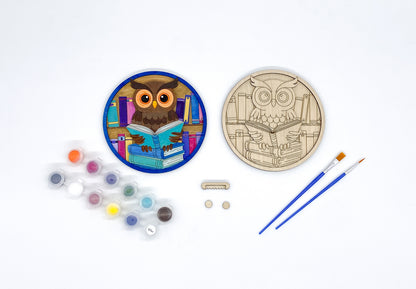 Painting kit with owl design, paint, and brushes on a white background