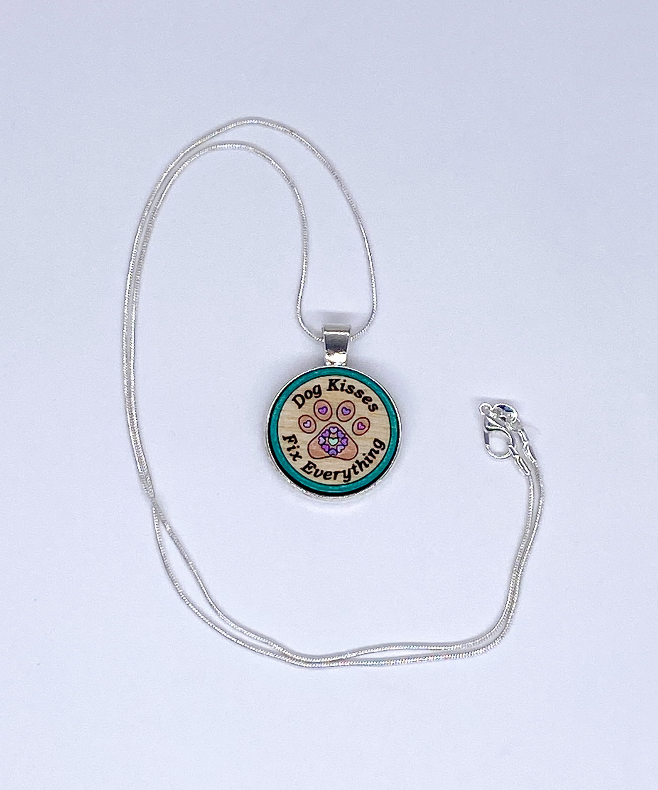 Wooden paw print pendant with heart accents on a silver-plated snake chain, handcrafted jewelry for pet lovers