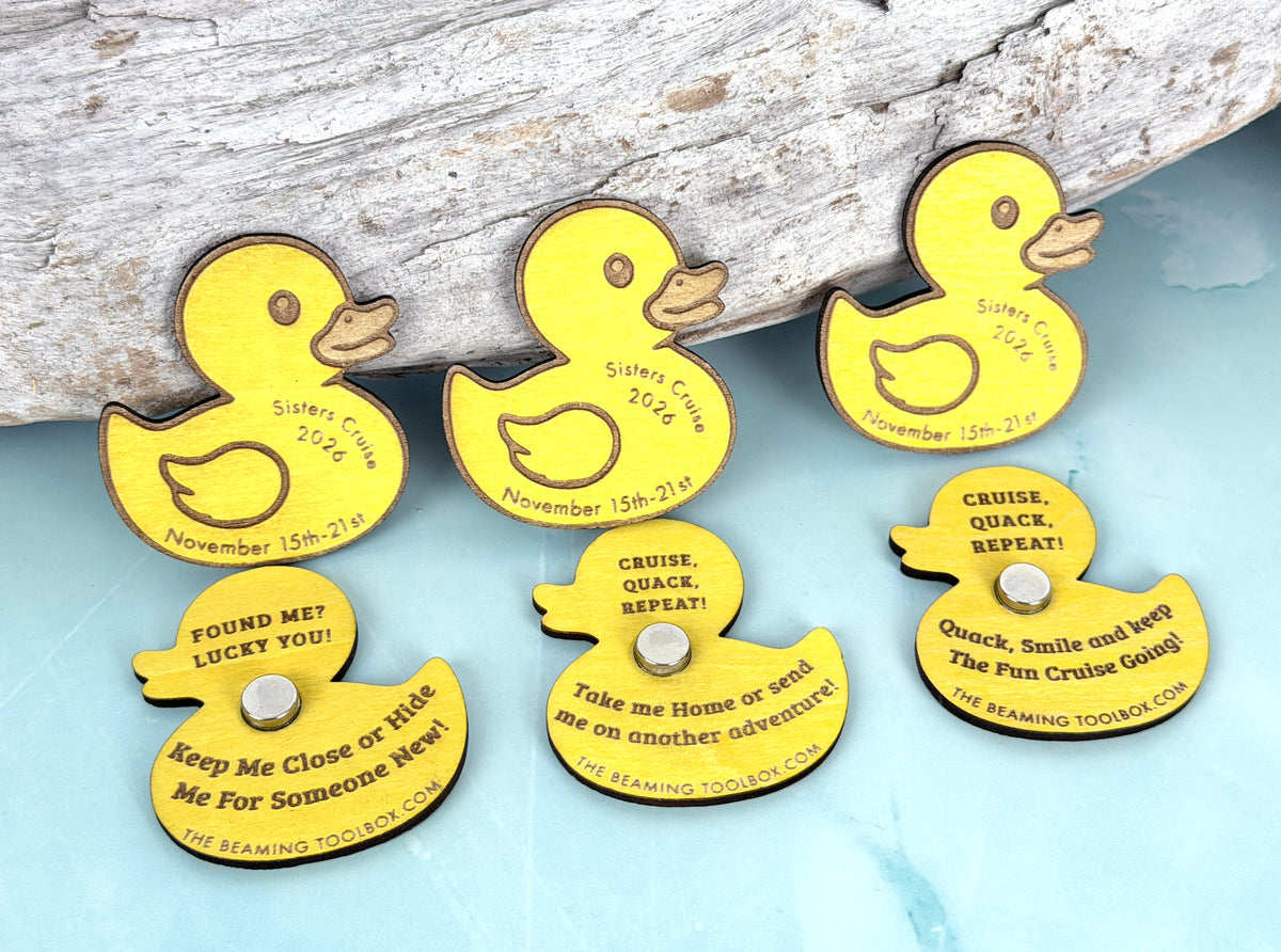 Yellow wooden cruise ducks displayed with custom ship names, sailing dates, engraved messages, and silver magnets against a coastal-inspired background.