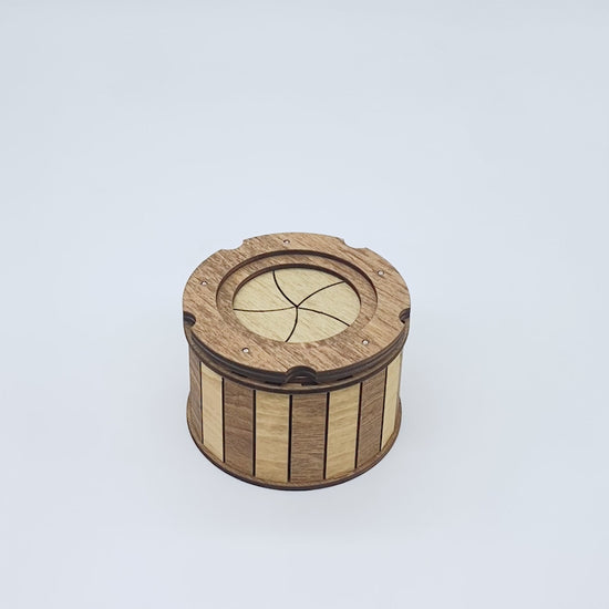 Watch the handcrafted wooden keepsake box smoothly open with its unique twist-open iris mechanism, revealing a hidden storage compartment perfect for jewelry, dice, crystals, coins, and other small keepsakes.