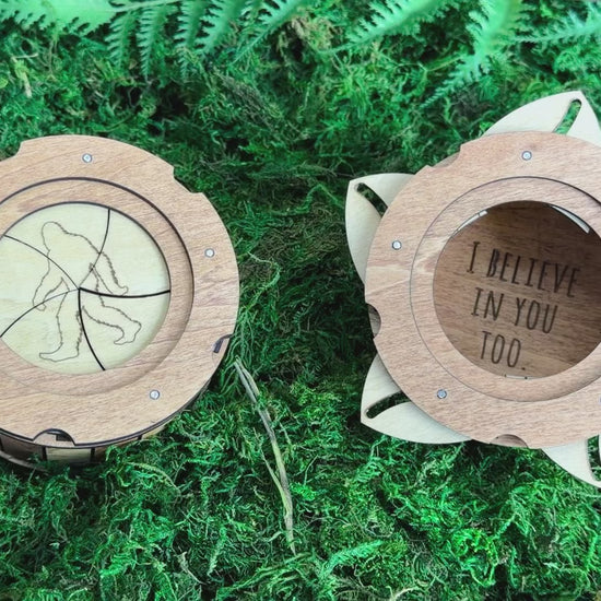 Handmade wooden Sasquatch iris box demonstrating the twist-open lid, revealing a hidden storage compartment for small treasures.