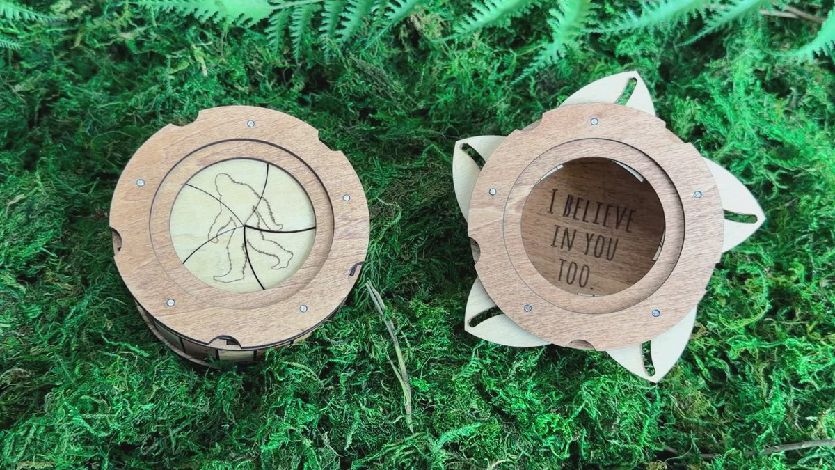 Handmade wooden Sasquatch iris box demonstrating the twist-open lid, revealing a hidden storage compartment for small treasures.
