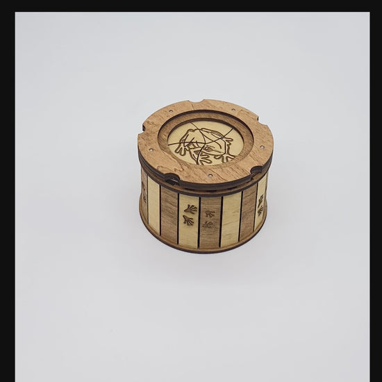 Short demonstration showing the handcrafted Frog Keepsake Box opening with its smooth twist-open iris mechanism to reveal the hidden engraved frog on a lily pad inside.