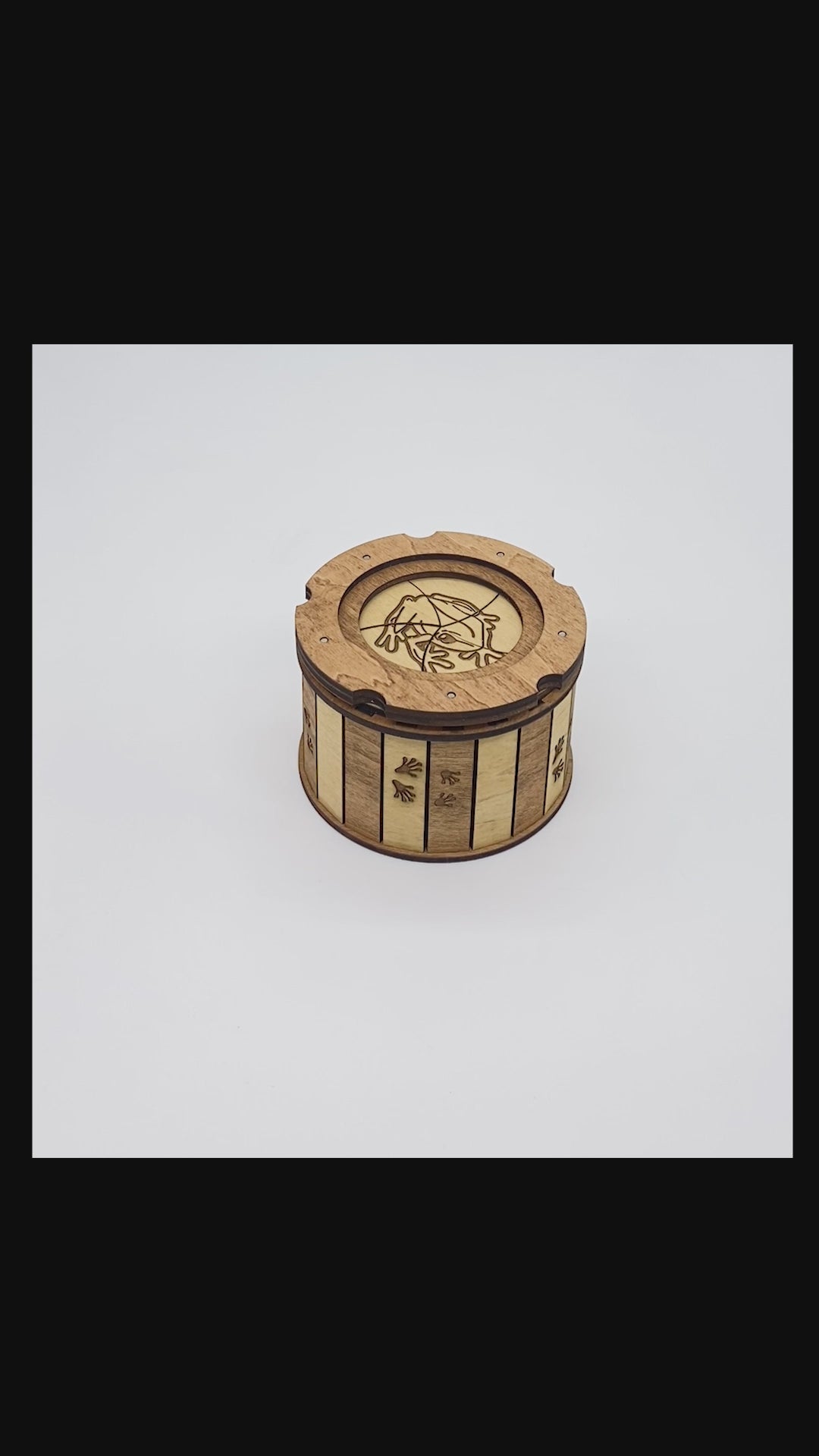 Short demonstration showing the handcrafted Frog Keepsake Box opening with its smooth twist-open iris mechanism to reveal the hidden engraved frog on a lily pad inside.