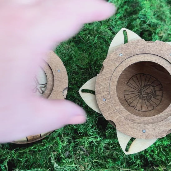 Handcrafted wooden frog iris box featuring an engraved frog lid, decorative frog footprints, and a unique twist-open mechanism revealing a hidden frog on a lily pad.