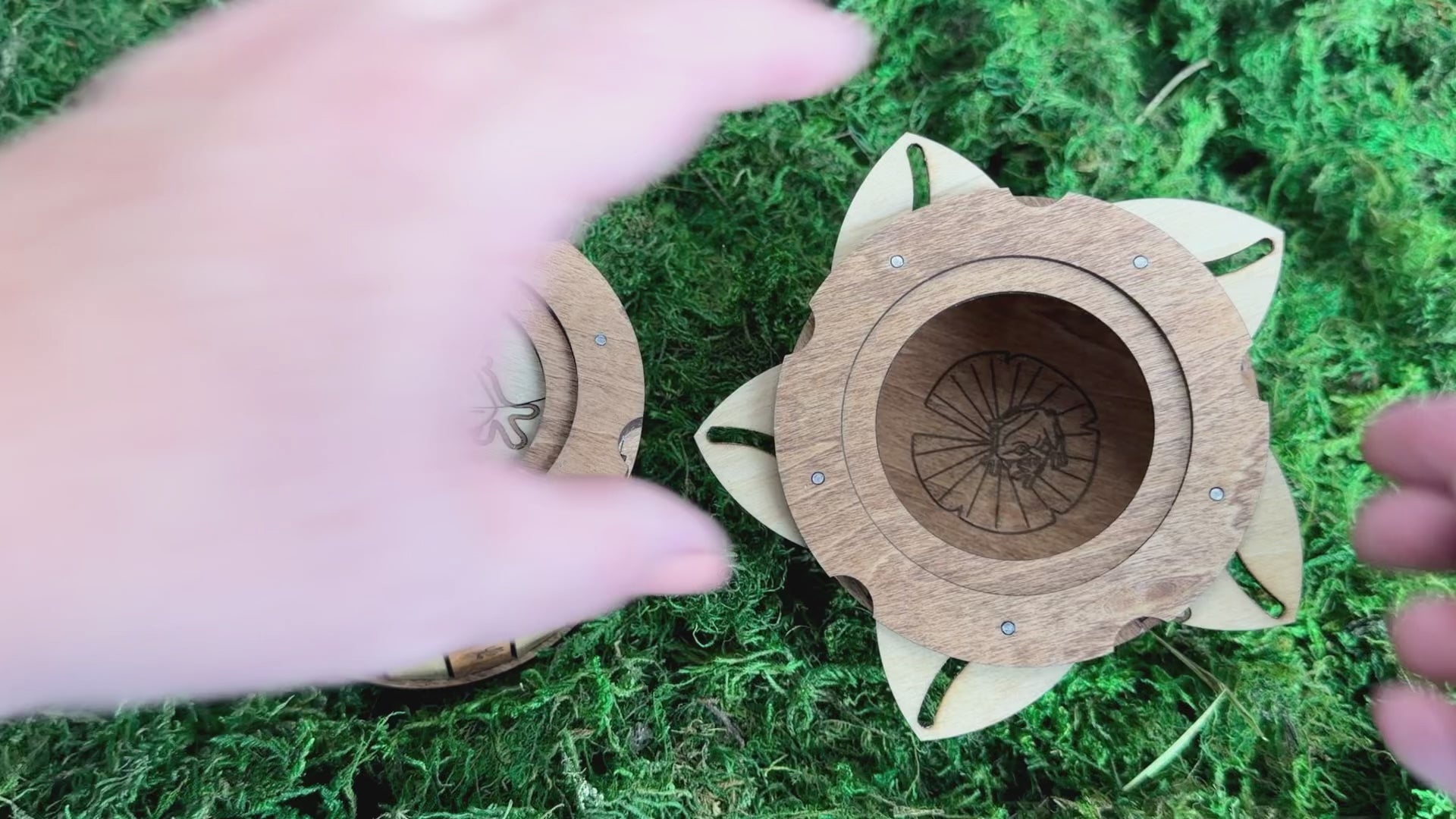 Handcrafted wooden frog iris box featuring an engraved frog lid, decorative frog footprints, and a unique twist-open mechanism revealing a hidden frog on a lily pad.