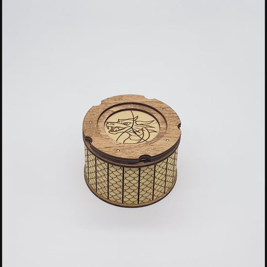 Video of opening and closing of wooden keepsake box with dragon engraved ontop of iris aperature top.  Inside has and engraved dragon's eye.  The outside is patterned with scales.
