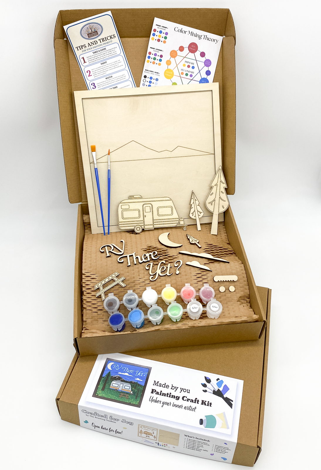 Boxed RV There Yet DIY paint kit packaging showing layered wood camper RV design and all included kit contents such as paint pots and brushes