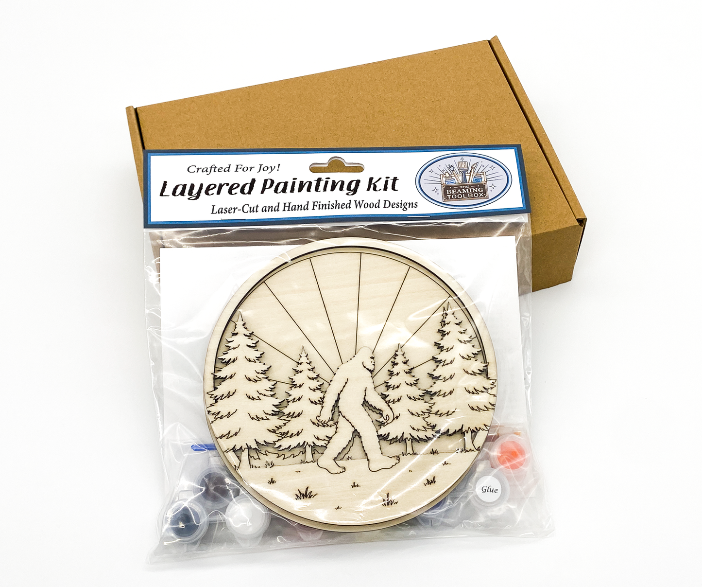 Professional retail packaging for the Sasquatch in the Forest 3D layered painting kit in a clear resealable bag with a brown shipping box