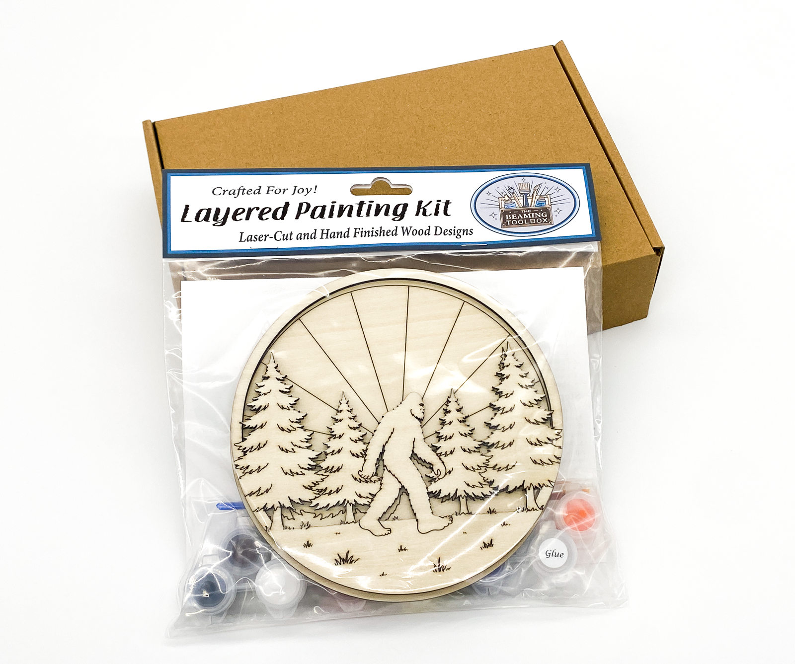 Professional retail packaging for the Sasquatch in the Forest 3D layered painting kit in a clear resealable bag with a brown shipping box
