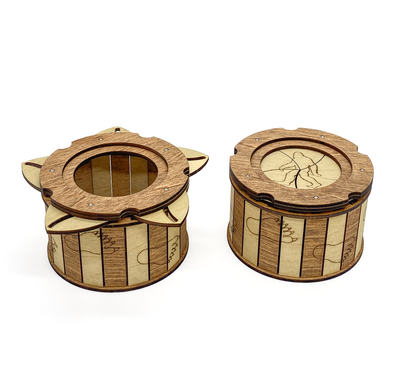 Wooden Sasquatch iris box shown open and closed featuring a twist-open iris mechanism and Bigfoot footprint engravings.