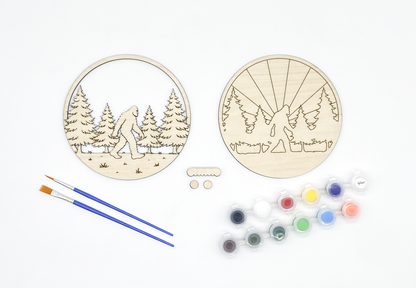 The two separate wood layers of the Sasquatch kit—the forest silhouette and the sunburst background—ready for DIY assembly and painting