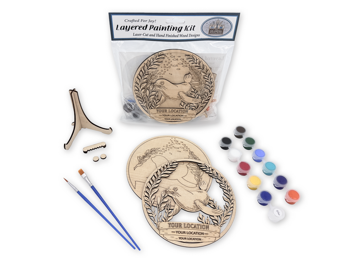 Complete Sea Lion custom location layered painting kit with wood pieces, paint pots, brushes, glue, stand, hardware, and packaging.