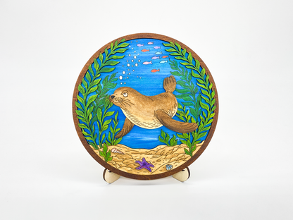 Finished sea lion kelp forest layered wood paint kit displayed on a white background, front view with painted ocean scene