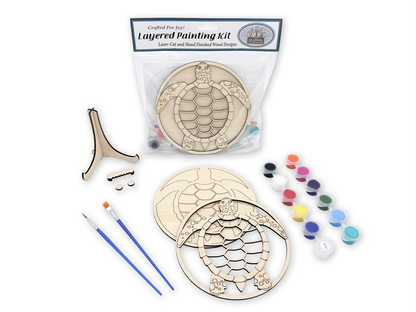 Packaged sea turtle layered painting kit with unpainted wood pieces, paint pots, brushes, glue, and display stand hardware.