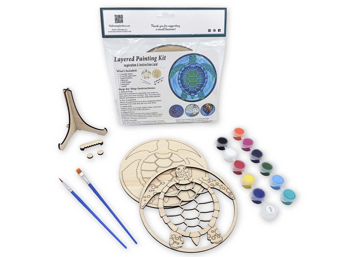 Sea turtle painting kit for adults with packaged kit, unpainted wood layers, paint pots, glue, brushes, and display stand pieces.
