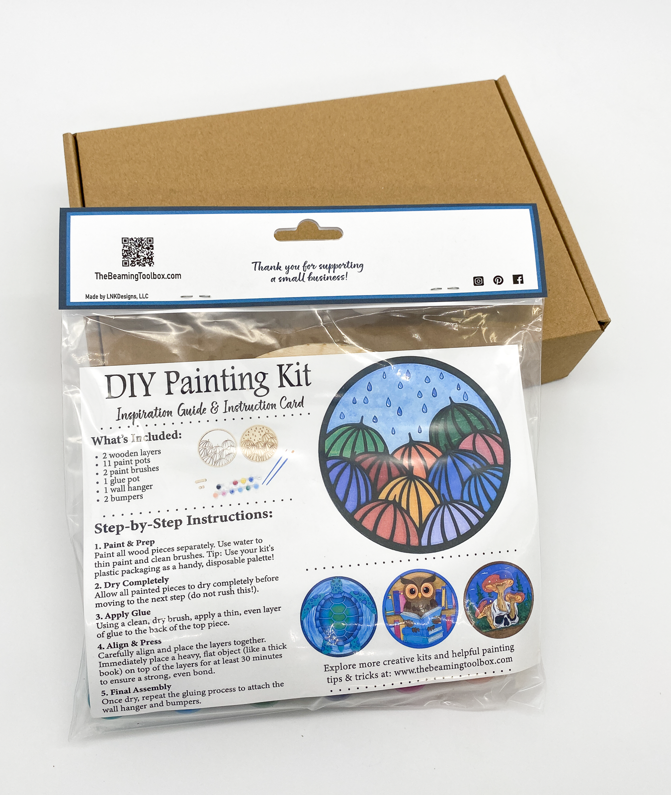 Back of Umbrellas DIY paint kit packaging with insert displaying finished painted umbrellas example and kit contents information