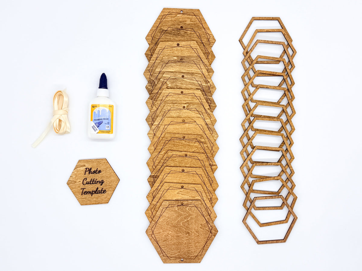 Stained wooden hexagon photo garland kit on a white background, with solid backings, open frames, cream ribbon, glue and a photo cutting template.